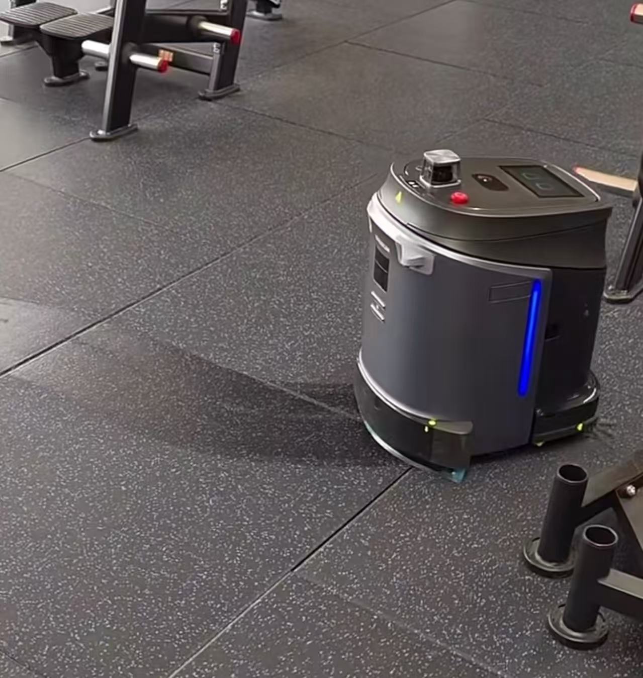 Phantas cleaning rubber flooring beside gym equipment